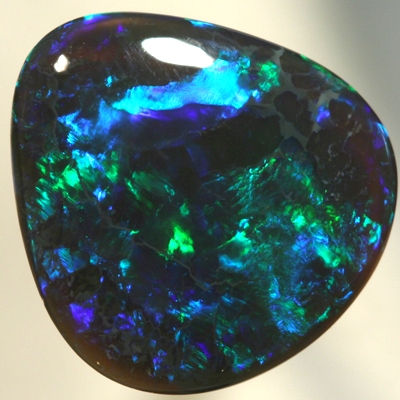 SOLID BLACK CRYSTAL OPAL Bright greens play over a background hue of purple blue SEE VIDEO
